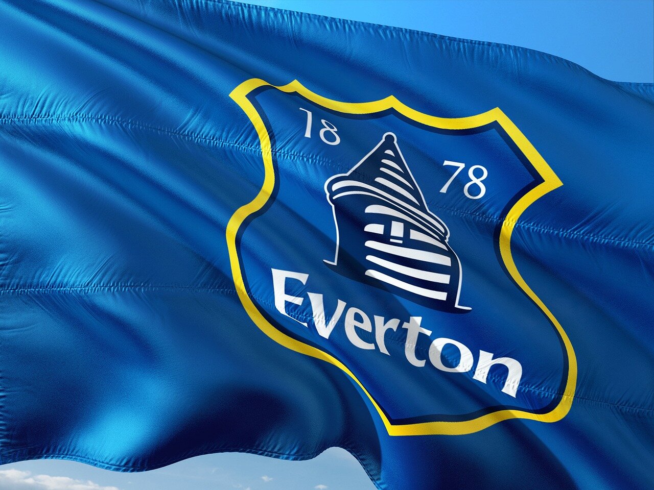 Fans of Everton cheering passionately from the stands, demonstrating their support and hope following the team's muchneeded win