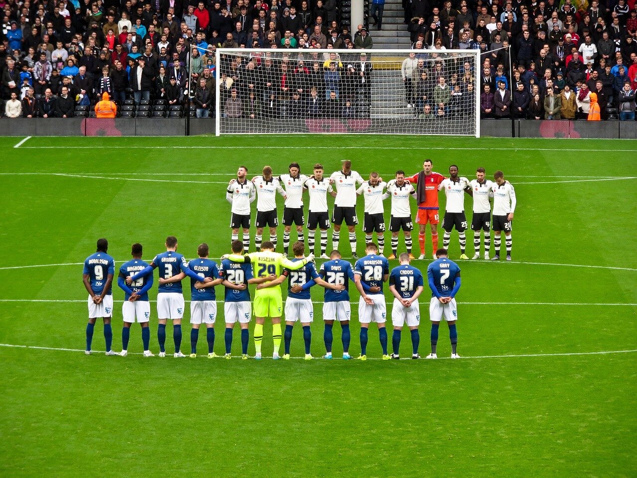 Fulham fans cheer enthusiastically from the stands, showcasing their unwavering support for the team during the match