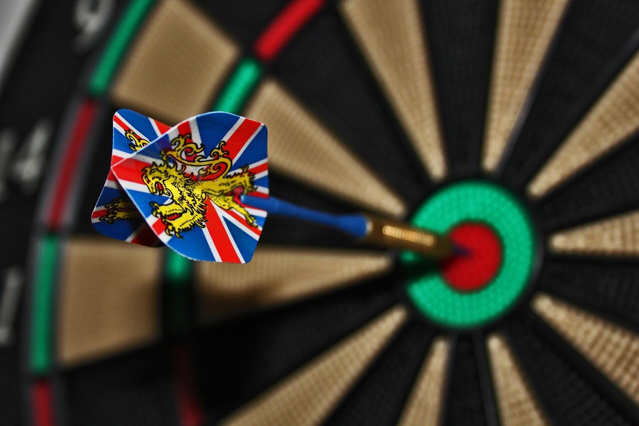 A closeup of the dartboard reveals the precision and skill required as players aim for their targets in the competitive setting