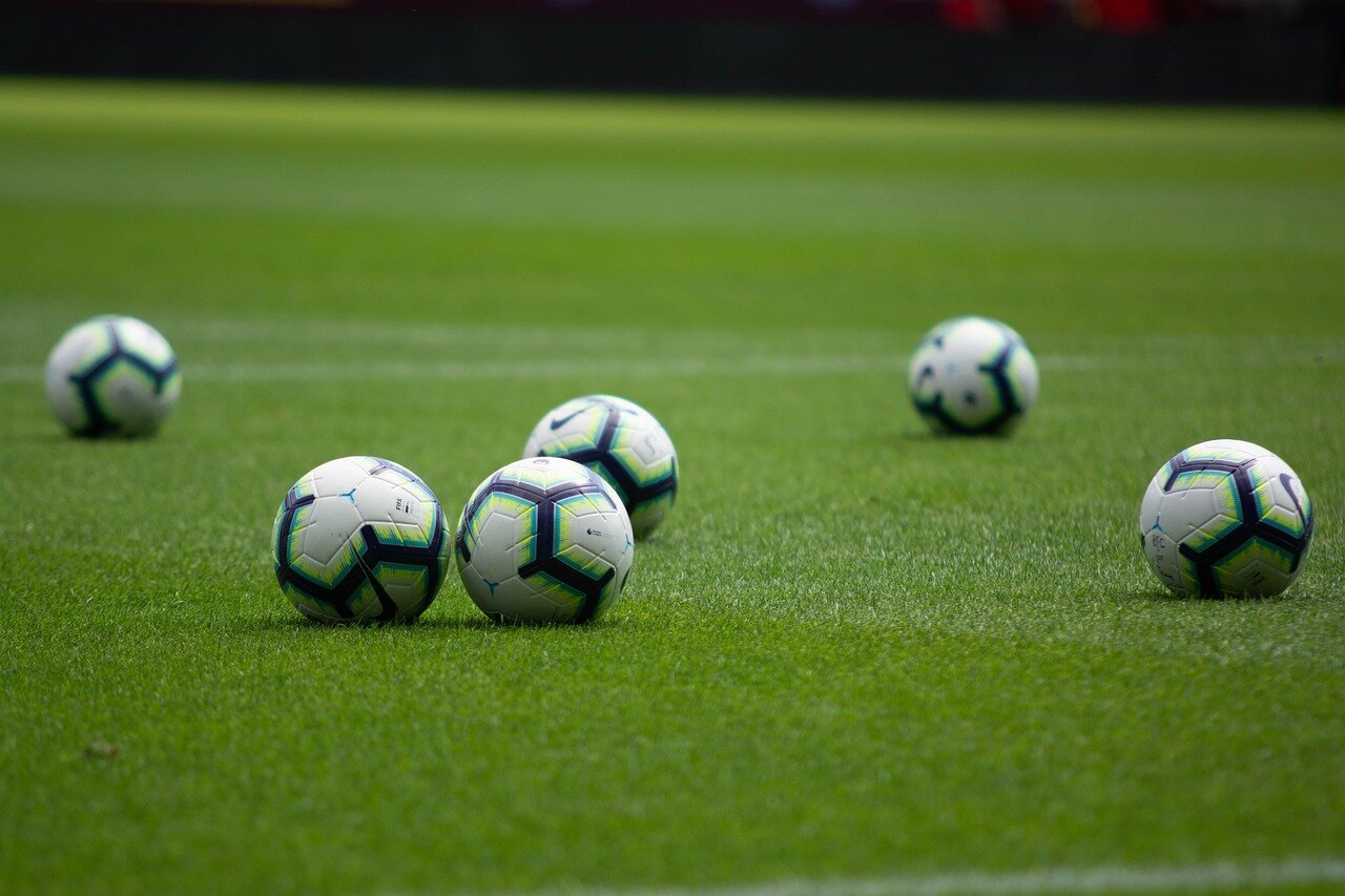 A packed stadium filled with passionate fans, capturing the vibrant atmosphere of a Premier League match while revealing the challenges of maintaining engagement amid rising costs
