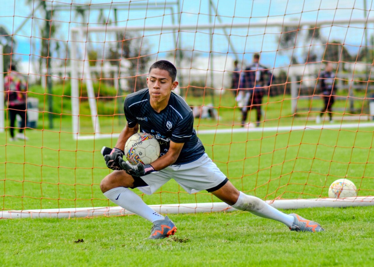 A closeup of Remiro in action, showcasing his focused expression as he prepares to defend against an opposing striker