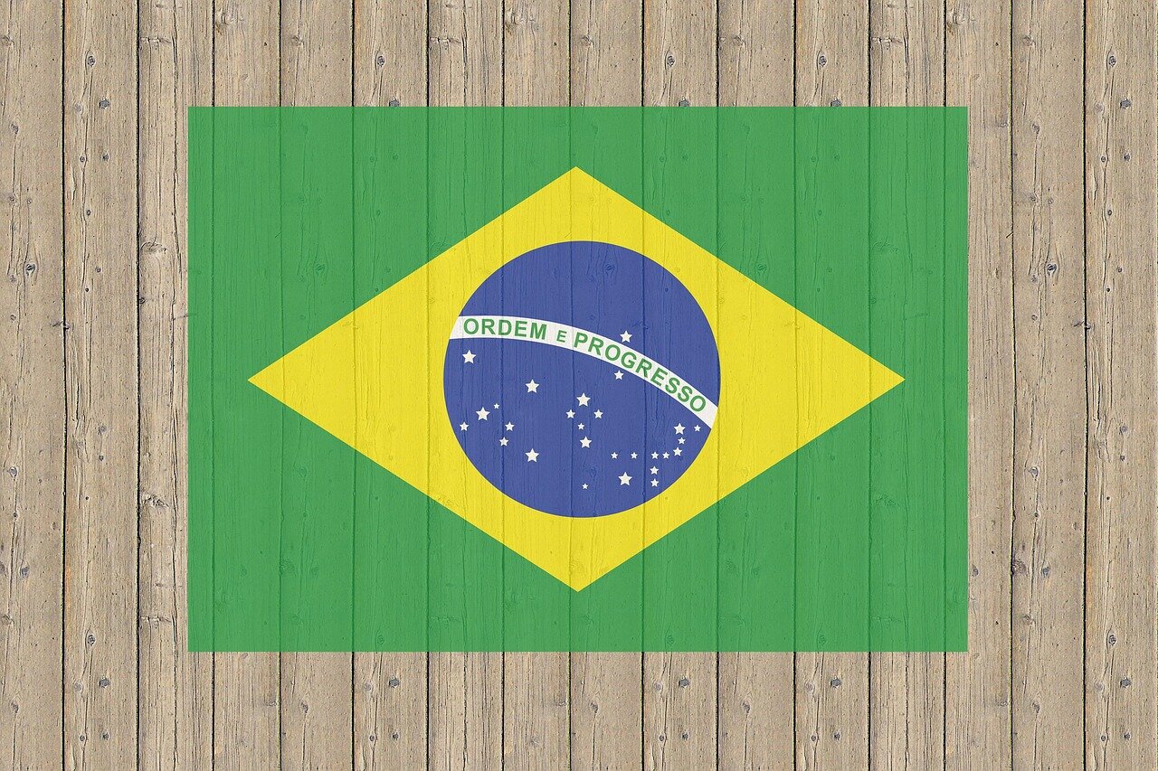 Fans gather in a bustling city square, eagerly discussing their excitement for the upcoming World Cup 2026 while holding colorful flags of the participating nations.