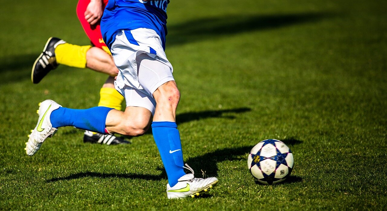 A sports analyst providing insights during a live broadcast, enhancing the football conversation for viewers